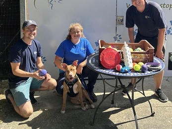 Trust staff Alex and Adam pose with National Animal Welfare Trust after donating collected beach balls