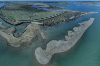 Dredged sediment creating an island of shingle around Old Hall Point 